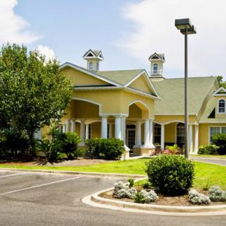 A picturesque house with a landscaped garden and driveway.