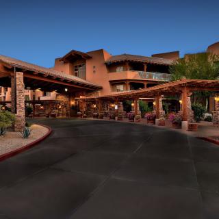 A welcoming entrance to a resort hotel during the evening.