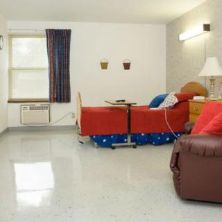 A clean hospital room with beds and medical equipment.