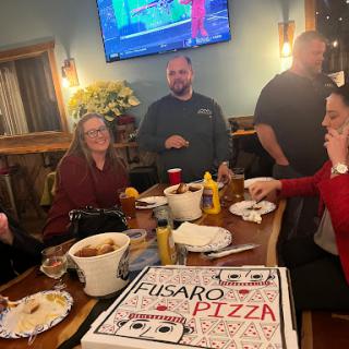 A fun evening with friends enjoying pizza and good company.