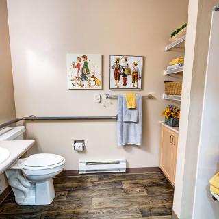Modern bathroom with accessible features and colorful decor.