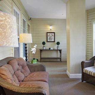 A cozy living room with a sofa, lamp, and decorative elements.