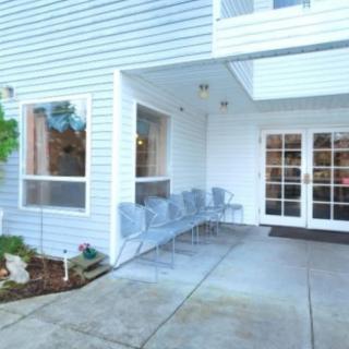 Entrance area with seating at a building exterior.