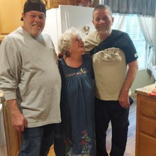 A joyful moment shared among family in the kitchen.