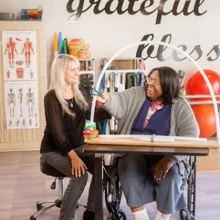 A supportive session in a wellness studio, highlighting collaboration in physical therapy.