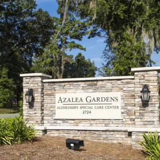 Entrance sign for Azalea Gardens with brick and stone design.