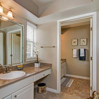 A well-lit bathroom with a large mirror and modern decor.
