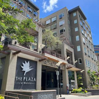 The Plaza: A modern building showcasing contemporary design amid urban greenery.