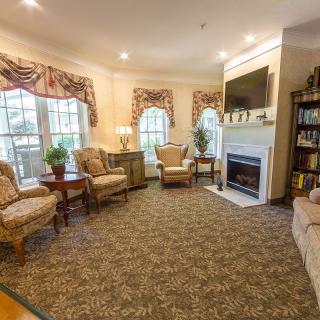 A cozy living room with elegant furniture and a warm fireplace.