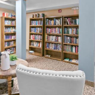 A cozy library interior with bookshelves and a comfortable reading area.