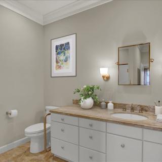 A modern bathroom featuring a stylish vanity, contemporary decor, and soft neutral tones.