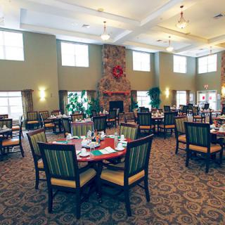 An elegantly arranged dining hall with neatly set tables and comfortable seating.