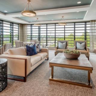 Contemporary living room with modern furniture and large windows.