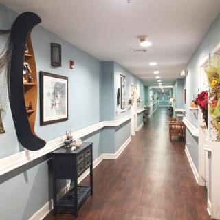 A modern hallway with artwork and decor along the walls.