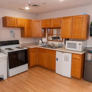 A cozy kitchen with wooden cabinets and modern appliances.
