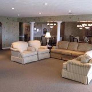 A spacious living room with comfortable seating and elegant lighting.