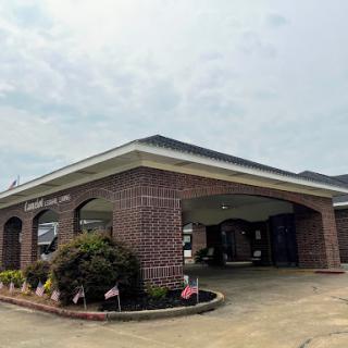 A brick building featuring a welcoming entrance and landscaped surroundings.
