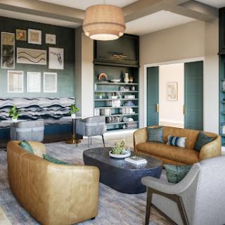 A stylish and modern living room featuring comfortable seating, curated artwork, and elegant shelving.