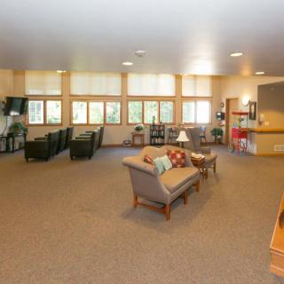 A spacious living room with comfortable seating and large windows.