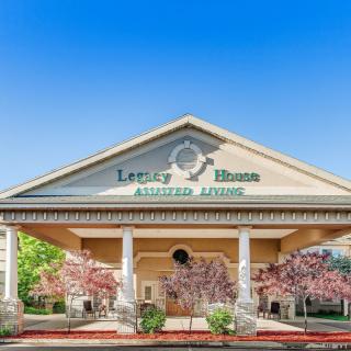 Entrance of an assisted living facility with elegant architecture.