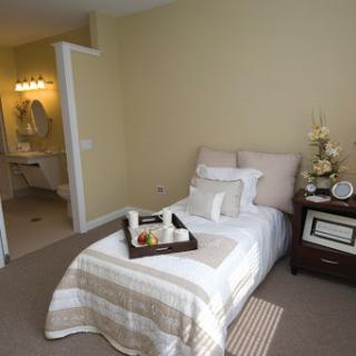 A cozy and elegantly decorated bedroom with a neutral color palette.