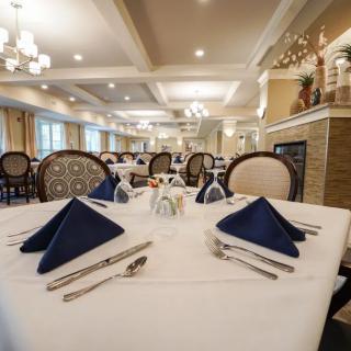 An elegantly set dining table in a well-lit restaurant.