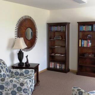 A cozy living room with bookshelves and stylish decor.