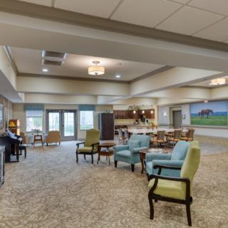 A spacious and cozy lounge area with comfortable seating and warm lighting.