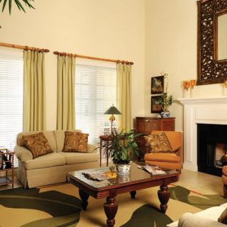 A cozy living room with a sofa, armchair, and a fireplace.