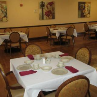 An empty restaurant dining area with tables set for service.