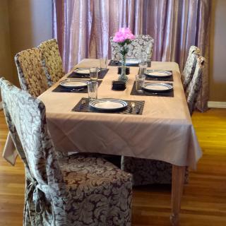 A well-set dining table with elegant decor and a flower centerpiece.