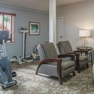 A cozy room with exercise equipment and comfortable seating.