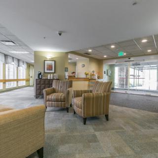 A modern lobby featuring comfortable chairs and a welcoming reception area.