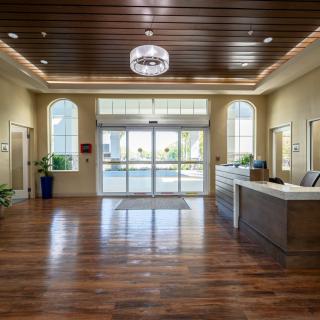 A modern lobby with a welcoming reception area and stylish wood flooring.