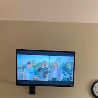 A scene from a movie playing on a television.