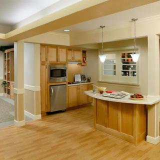 Modern kitchen with an open layout and wood flooring.