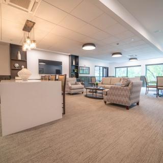 A modern and spacious living room with cozy seating and stylish decor.