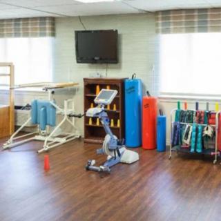 A therapy room equipped with various exercise and rehabilitation tools.
