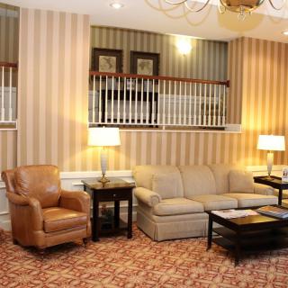 A cozy living room with a sofa, armchair, and stylish decor.