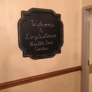 A decorative welcome sign at the entrance of a health care center.
