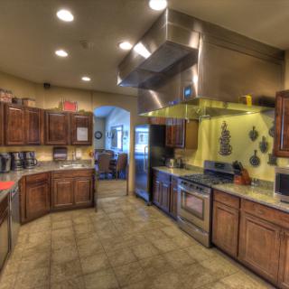 A spacious and modern kitchen featuring wooden cabinets and stainless steel appliances.