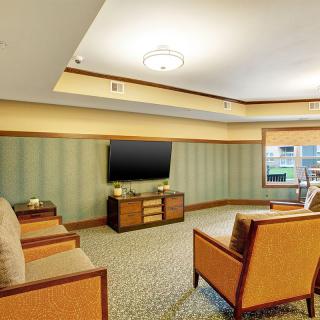 A modern living room with comfortable seating and a flat-screen TV.