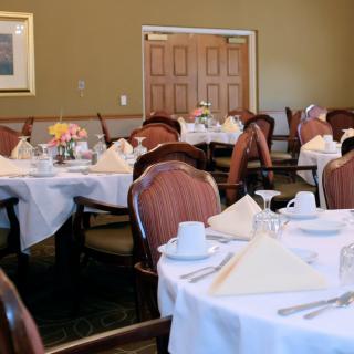 An elegant dining room with tables set for guests.