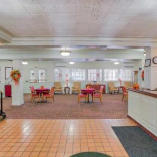 An empty dining area with tables and chairs arranged neatly.