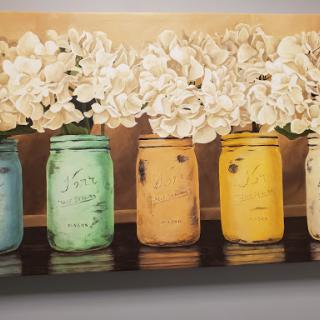 A charming arrangement of colorful jars filled with elegant flowers, perfect for brightening any space.