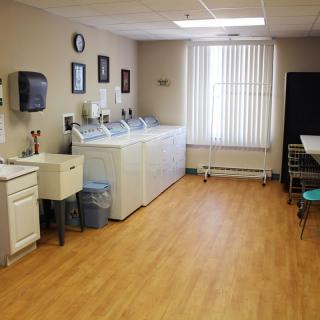 A well-organized laundry room with washing machines and a sink.