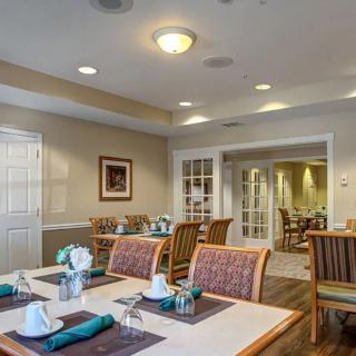 A cozy dining area with neatly arranged tables and chairs, ready for guests.