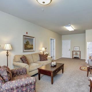 A cozy living room with a sofa, coffee table, and lamps.