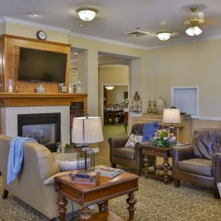 A cozy living room with a fireplace, television, and comfortable seating arrangement.