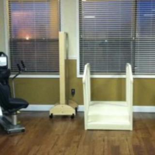 A room with exercise and rehabilitation equipment, including a stationary bike and therapy stairs.